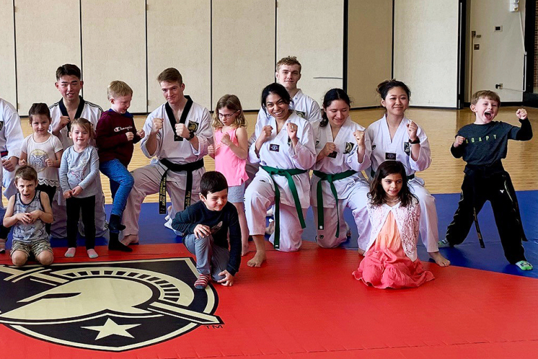 The Army martial arts team with the participants of the Taekwondo for Kids Day March 19 at Eisenhower Hall.