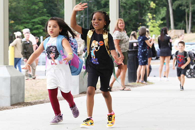 West Point Elementary School students return for the first day of school after a long summer on Monday. The students were greeted by several people including their teachers and the Rabble Rousers (bottom left), who motivated the children as they walked into the school.     			       															                    Photos by Capt. David Hoy/USMA PAO