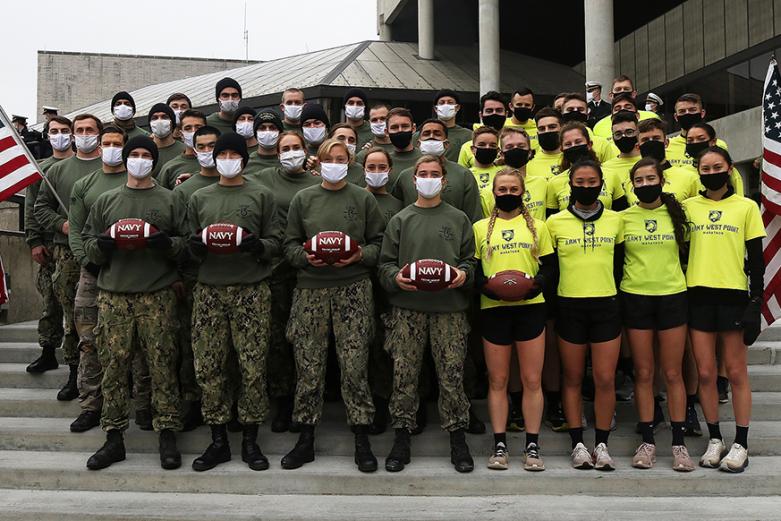 Members of the Army West Point Marathon team and the U.S. Naval Academy’s 13th Company get together on the steps of the Holleder Center after the 5-kilometer esprit de corps run to finish the Army-Navy Ball Run prior to Saturday’s Army-Navy Game. 