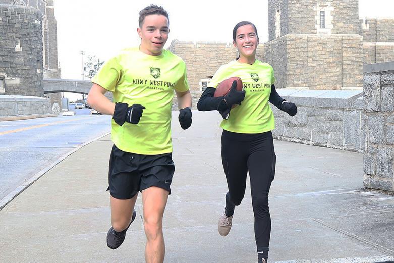 Class of 2024 Cadets Wesley Anderson (left) and Daniela Etzel participate in the Army-Navy Ball Run Friday on West Point. With the Army-Navy Game changed to West Point because of safety concerns due to COVID-19, the Army West Point Marathon team came up with the concept of a 24-hour endurance challenge to run on post. The team ran more than 400 miles during the 24 hours.