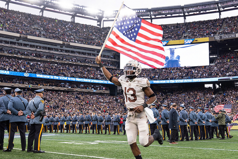 The Army West Point football team entered the field carrying American flags (top and above right) and the Army West Point Marathon team (above left) took a photo in front of the 9/11 ʽNever Forgetʼ sign prominently displayed in order to pay homage to those affected 20 years ago at the 122nd annual Army-Navy Game Saturday at MetLife Stadium in East Rutherford, N.J. 