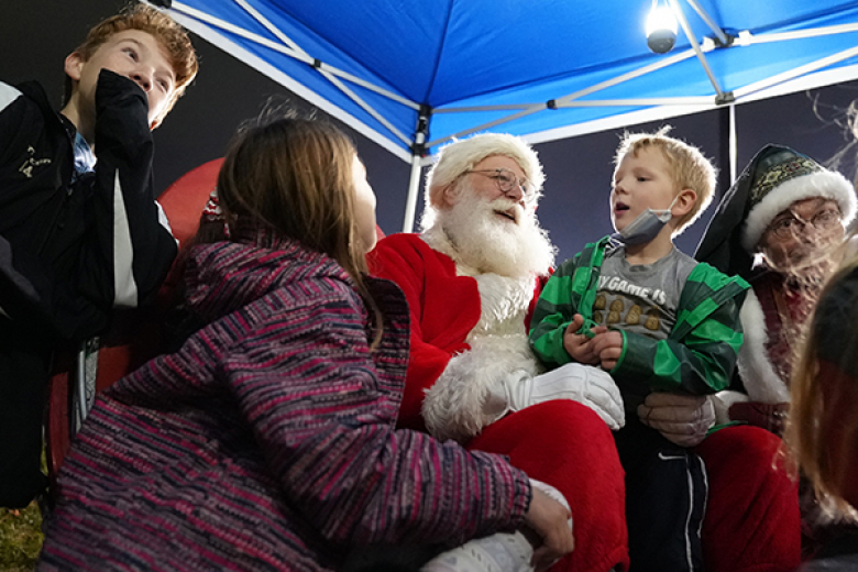 The holiday season went into full throttle as West Point celebrated its annual holiday tree lighting ceremony, hosted by West Point Morale, Welfare and Recreation, Monday at the Exchange. Beyond the lighting of the tree (top), the evening included music from the West Point Cadet Chapel Choir, West Point Band Brass Quintet, the distribution of trees by the Tree for Troops organization and a visit from Santa. (Below) Santa met with the children of the West Point community.  	