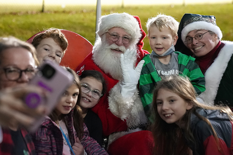 The holiday season went into full throttle as West Point celebrated its annual holiday tree lighting ceremony, hosted by West Point Morale, Welfare and Recreation, Monday at the Exchange. Beyond the lighting of the tree (top), the evening included music from the West Point Cadet Chapel Choir, West Point Band Brass Quintet, the distribution of trees by the Tree for Troops organization and a visit from Santa. (Below) Santa met with the children of the West Point community.  	