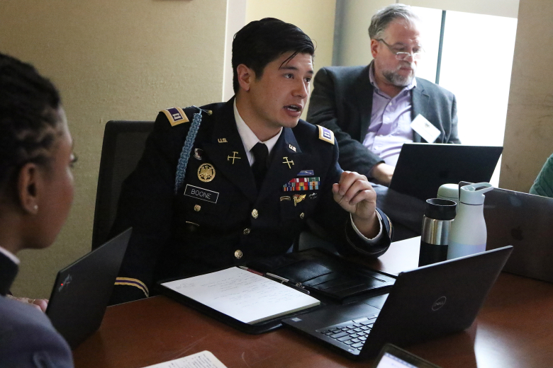 Capt. Merlin Boone, Department of Social Sciences instructor, performs his duties as the chair during the “China and International Order – International Relations Perspectives” panel Feb. 9 at Jefferson Hall.