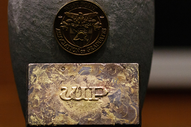 The gold ingot with the crucible after the melting process.