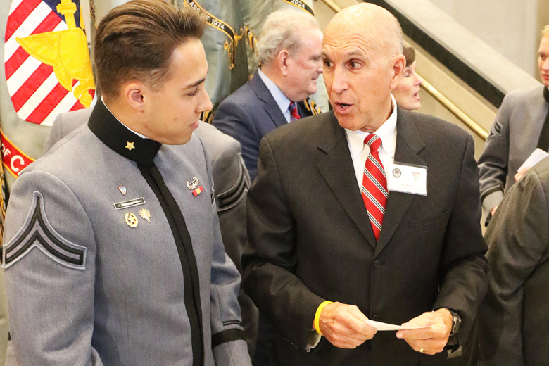 Class of 2024 Cadet Jorge Hurtado speaks with Bill Molloy, the son of Col. Cornelius Molloy Jr., U.S. Military Academy Class of 1944, before the Ring Melt Ceremony Friday at Crest Hall. 		              Photo by Eric S. Bartelt/PV