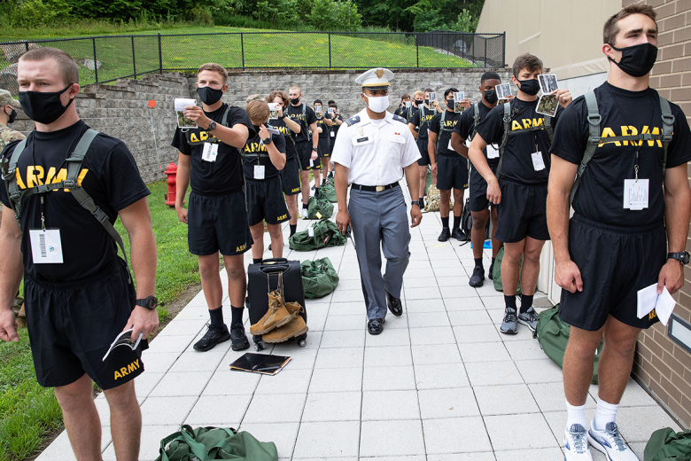 As cadet candidates wait to move onto the next station, they study their cadet candidate handbook, learning the basics of cadet life, which they will master in the coming weeks.