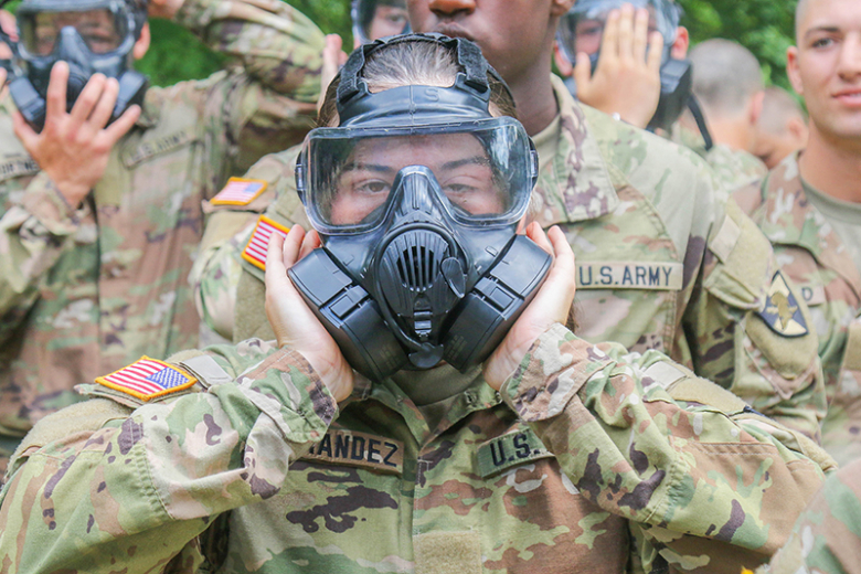 A new cadet checks the functionality of her protective mask prior to moving into the “The House of Tears.ˮ 				    Photos by Spc. Kelvin Johnson Jr./40th Public Affairs Detachment