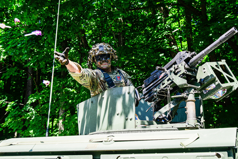 A Soldier assigned to Task Force Leader tossed candy from a military vehicle to onlookers.