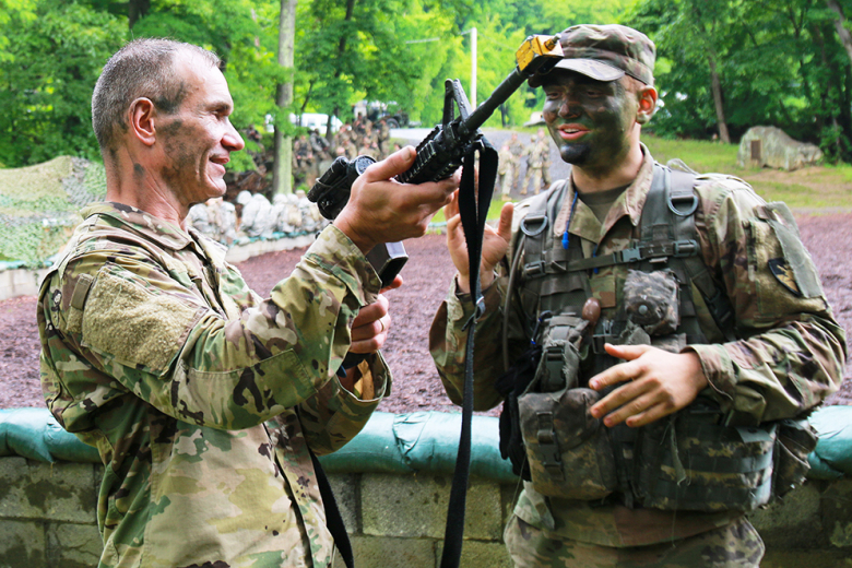 Robert Goscicki (left), a scheduling specialist with the Dean at the U.S. Military Academy, learns from Class of 2025 Cadet Harrison Wepener on how to properly check the functions of an M4 Carbine during the Civilian-Military Experience June 2 at Camp Buckner. 