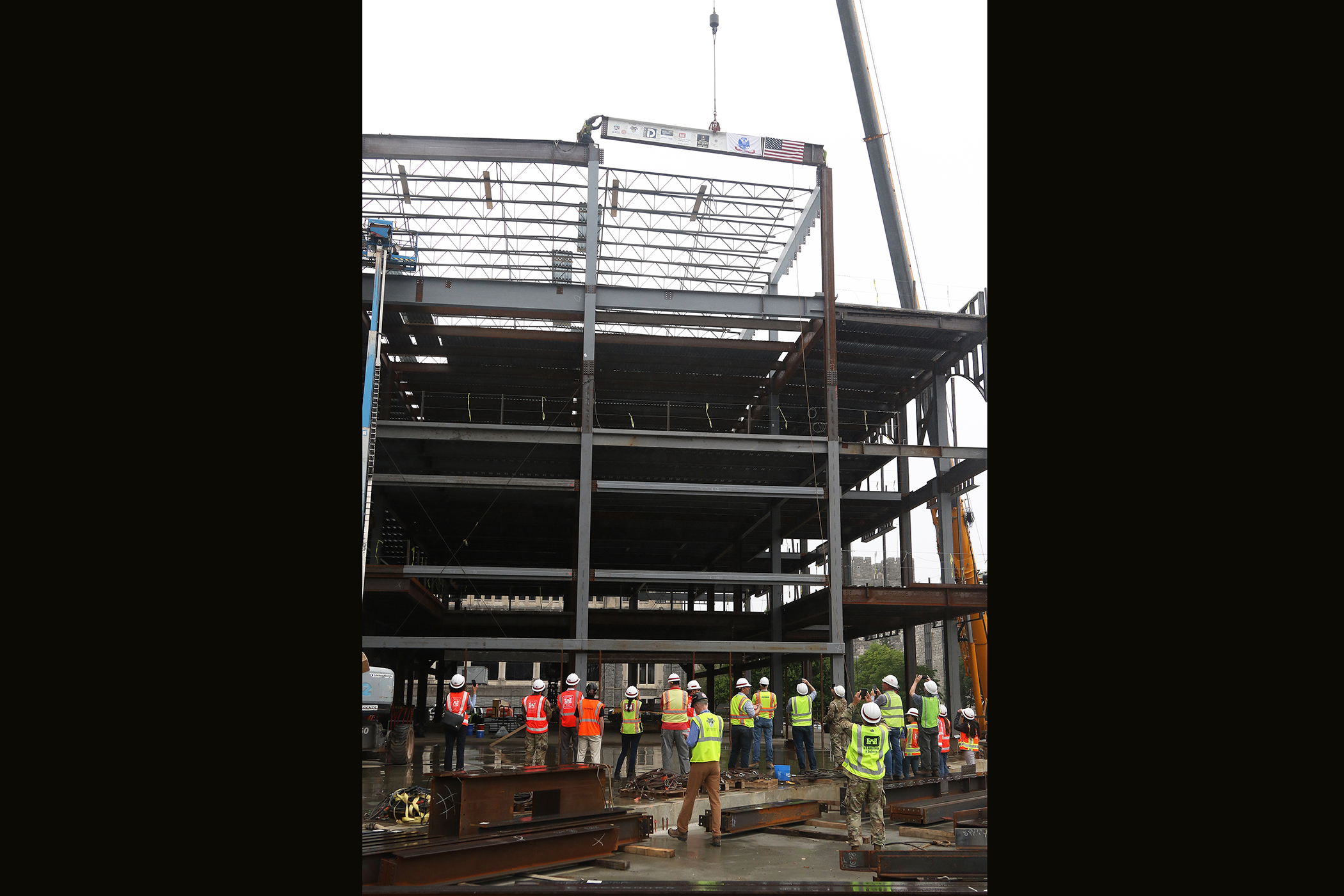 One of the final beams was placed on top of the future Cyber and Engineering Academic Center (CEAC) during a ceremony June 22 at the U.S. Military Academy. Traditionally, a beam topping ceremony is the celebration of the last beam placed on the building and marks a major milestone in the construction process of that building.  (Photo by Eric S. Bartelt/PV)