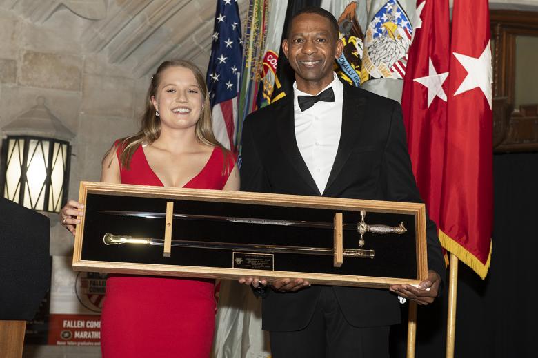 Class of 2021 Cadet and Class President Katarina Christianson presents a cadet sabre to guest speaker Command Sgt. Maj. Michael A. Crosby, command sergeant major of U.S. Army Futures Command, after he spoke during the 100th Night Banquet Friday. 