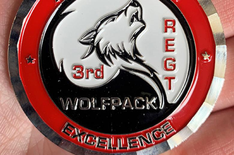 Class of 2023 Cadet Erika Rapp (on left in right photo) received a 3rd Regiment coin of excellence (left photo) from 3rd Regimental Tactical Officer Lt. Col. Kwenton Kuhlman (on right in right photo) for her honesty and integrity in going to her instructor about an answer she got incorrect that was marked correct on her quiz. 