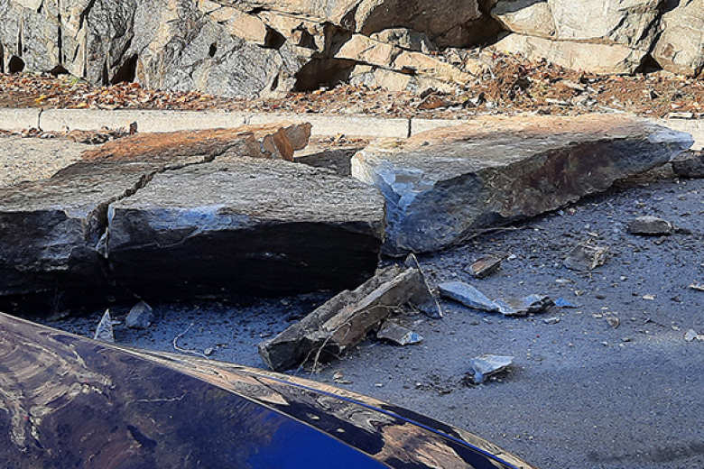 On Tuesday morning, a slab of rock along the rock wall on Williams Road, the road behind Taylor and Mahan Halls near the train station at South Dock, fell into the road. Luckily, there was no damage to the vehicles parked near the slide or anyone hurt by the debris. The Military Police was on the scene to block off the road until the Directorate of Public Works engineering crew came to successfully move out the rock. As it stands, there will be no restriction of traffic, but nine parking slots are closed