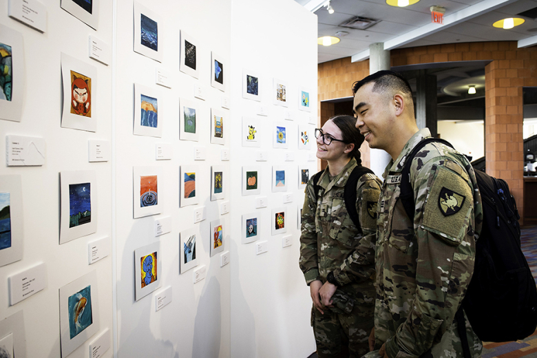 The U.S. Military Academy Library unveiled the tiny art exhibit — Magnificent Miniatures — of 95 pieces of original artwork on Oct. 23 and is now open to view. The idea to host a Tiny Art Show, featuring miniature canvases painted by USMA cadets, came from Programming and Event Librarian Lori Mulloolyʼs (bottom left photo to the right) vision. Miniature art is a genre of small-scale art that includes paintings, prints, sculptures and more and has a long history of its own. This program and exhibit