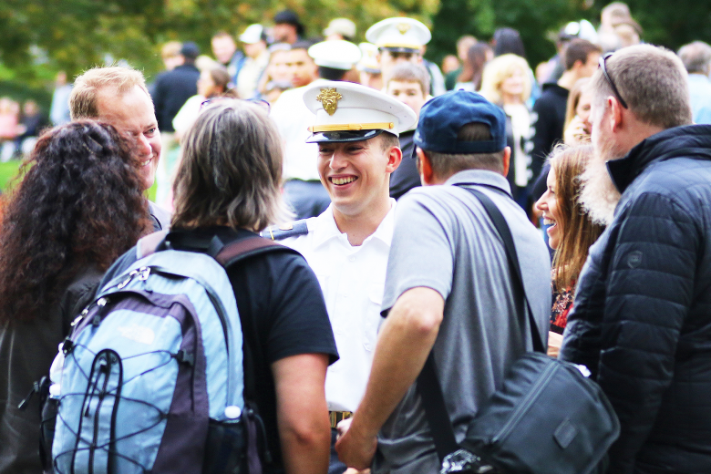 A cadet shares a laugh during his conversation with his family during Family Corps Weekend Friday at Trophy Point.                        