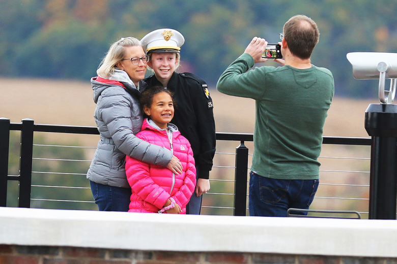 A cadet shares a laugh during his conversation with his family during Family Corps Weekend Friday at Trophy Point.                          