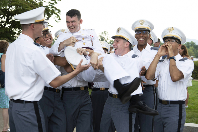 Class of 2026 cadets recite the ring poop while marveling at a Class of 2023 cadetʼs ring. 