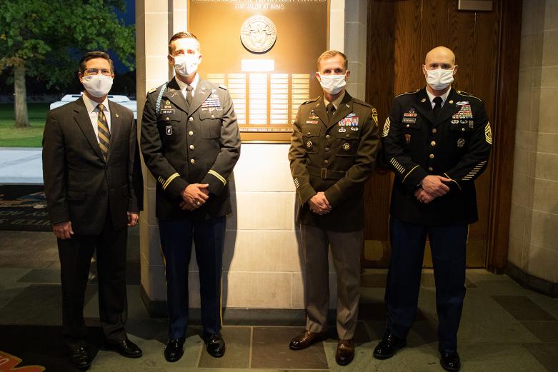 Maj. John A. Meyer (second from left), U.S. Military Academy Class of 2005, stands with the Commandant of Cadets  Brig. Gen. Curtis A. Buzzard (second from right), Association of Graduates President Todd Browne and U.S. Corps of Cadets Command Sgt. Maj. Kenneth Killingsworth Oct. 22 in front of the Alexander R. Nininger plaque.