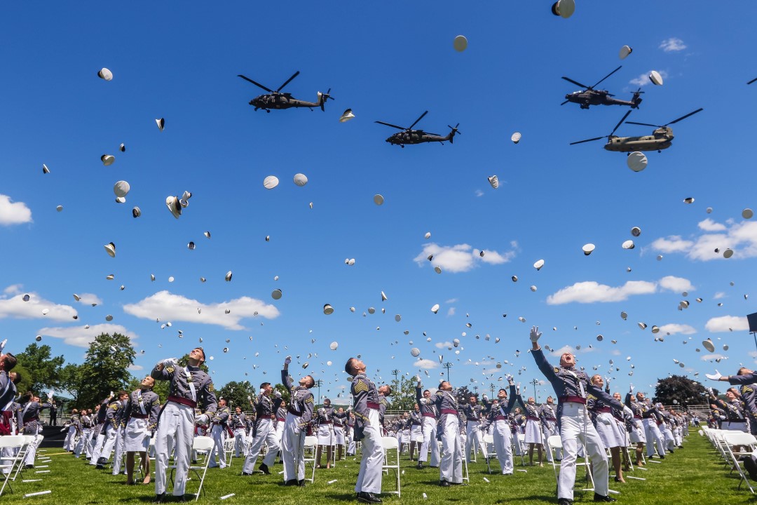 Cades throw their caps into the air at the completion of the graduation ceremony.