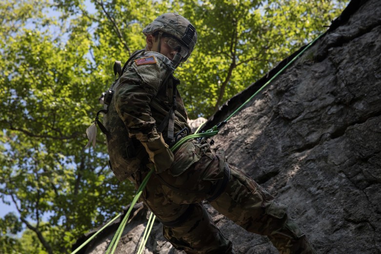 A cadet rappelling down a cliff.