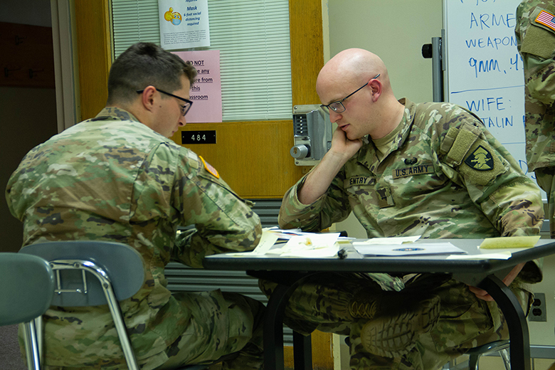 Cadets coordinate as a team to save a notional hostage during a crisis as part of the Hostage Negotiation Conference Aug. 2-6 at the U.S. Military Academy. Each cadet on the team was assigned a position ranging from speaking with a hostage-taker to intelligence gathering — recording pertinent information on a white board. 