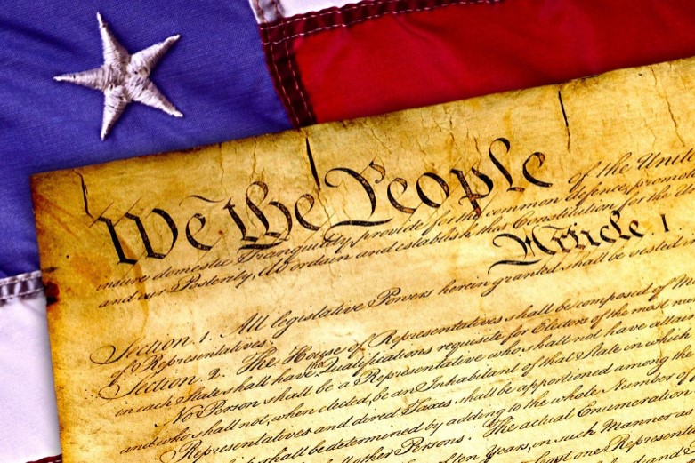 Image of American constitution atop of American flag
