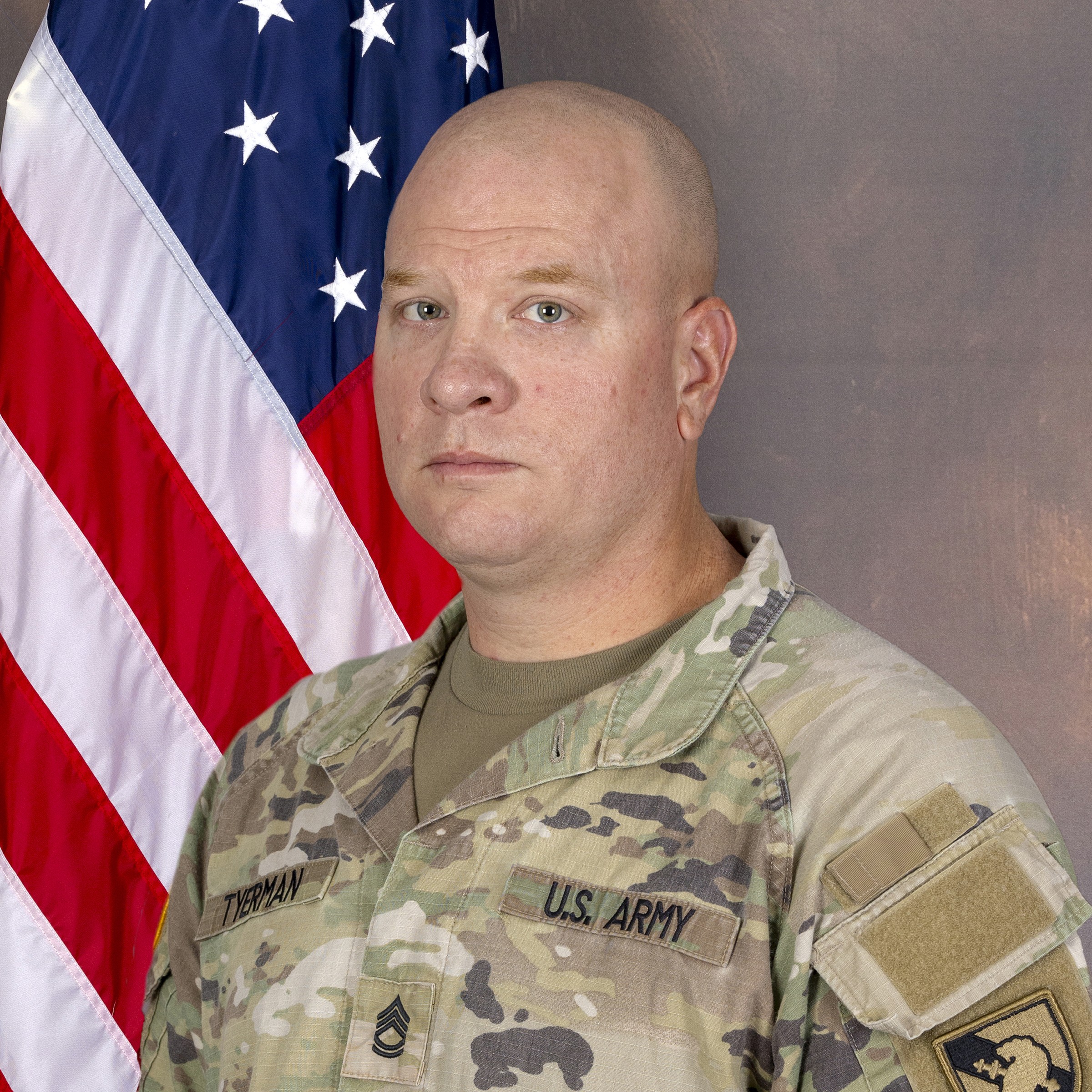 Portrait of SFC Tyerman in ACU before the US Flag