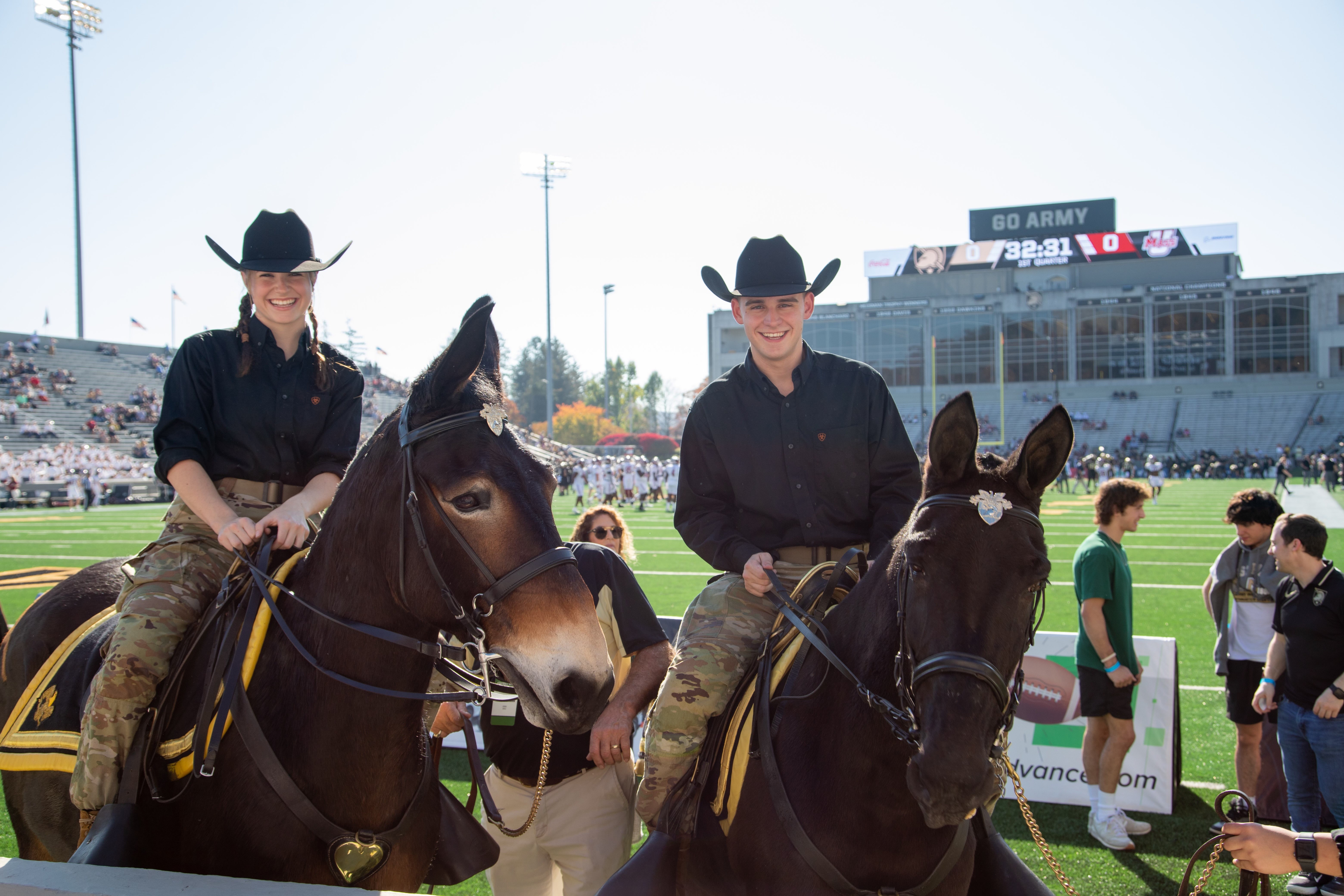 Army mules being ridden by cadets