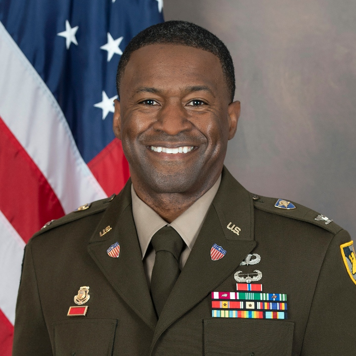 COL Archie Bates in AGSU in front of American flag.