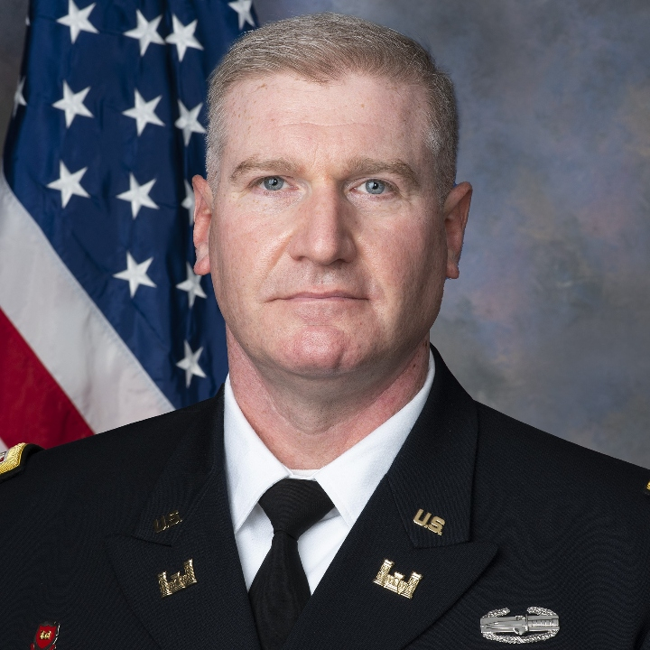 LTC Clemence "Carl" Oborski in AGSU in front of American flag.