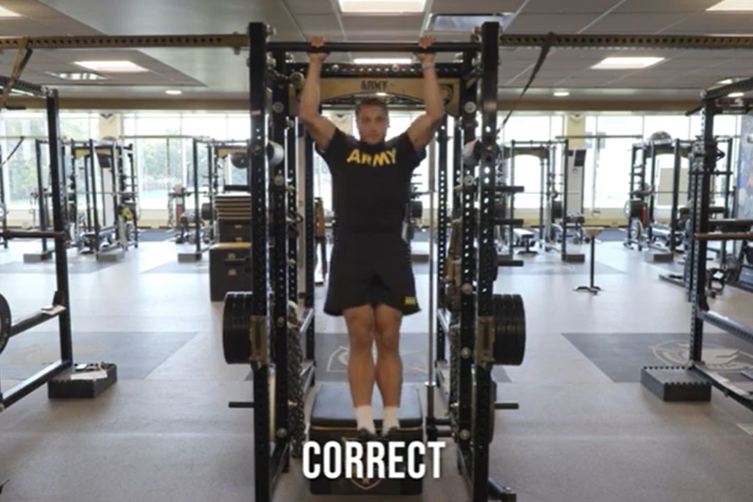 Man practices pull-ups.