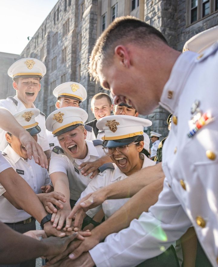 Cadet shows ring to other cadets.