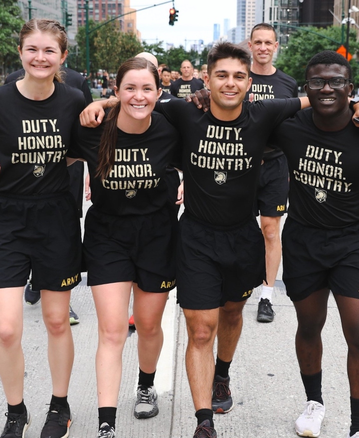 Four cadets walk together while wearing duty, honor, country T-shirts, one of the ways West Point offers cadet support.