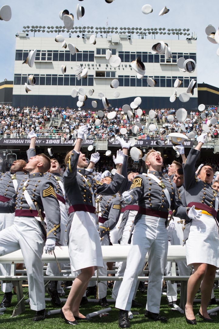 Cadets throw their caps in the air at graduation.