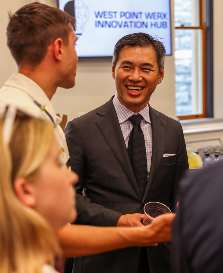 An old grad speaks to a cadet at the opening of the West Point Werx.