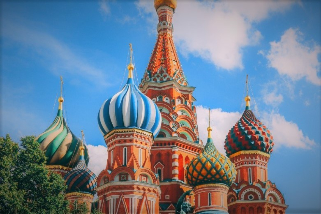 Colorful close-up view of Saint Basil’s Cathedral in Moscow, featuring its distinctive onion-shaped domes decorated with vibrant patterns in blue, green, red, and gold.