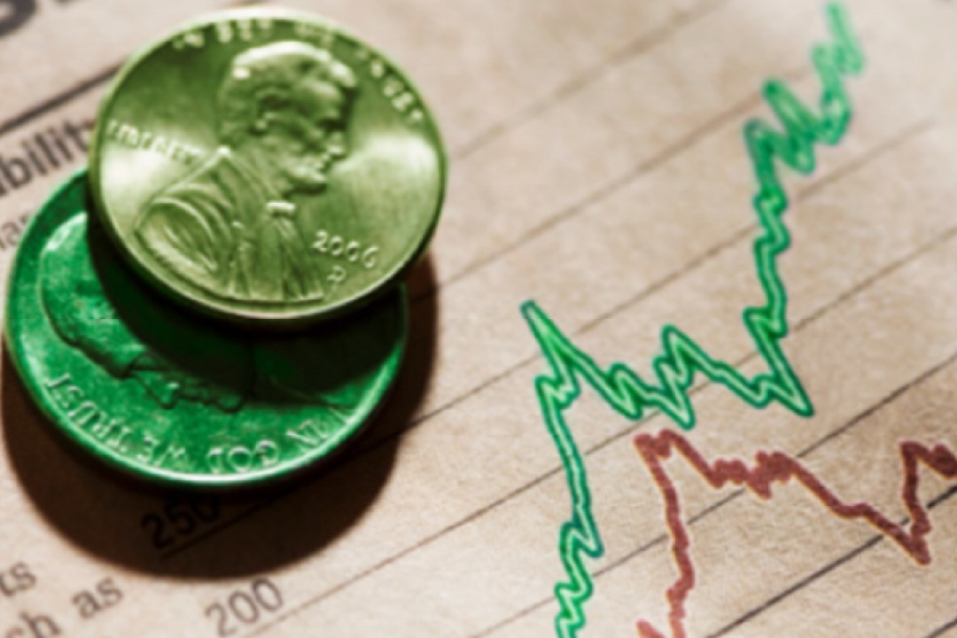 Two pennies rest on a financial chart with rising and falling trend lines, symbolizing money, investment, and market performance.