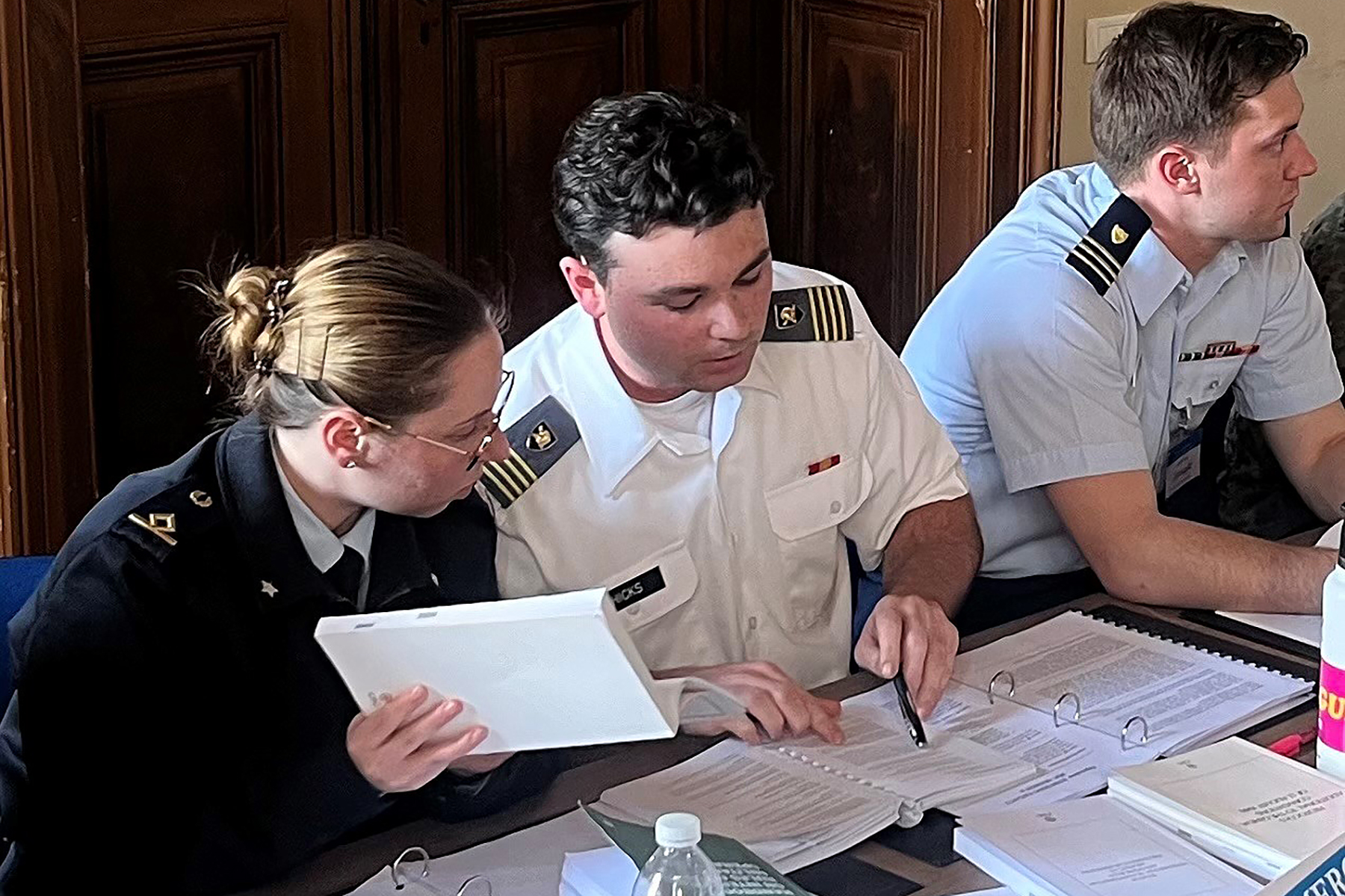 Class of 2024 Cadet Camron Hicks consults with a teammate from Italy, delving into treaty obligations relevant to their mission.   (Photo provided by Department of Law)