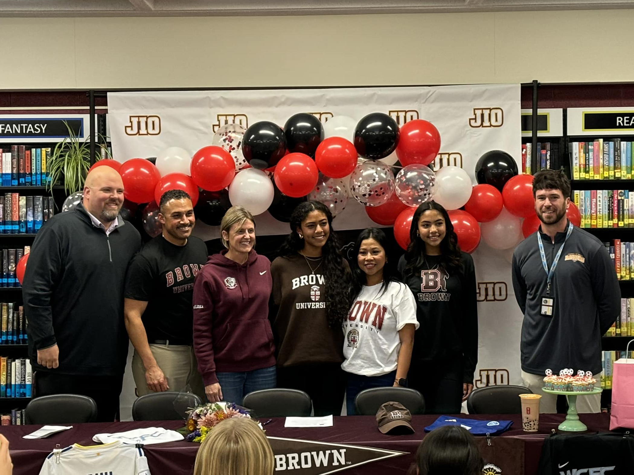 Jael-Marie Guy poses with her family and school officials after signing her National Letter of Intent to play soccer at Brown University beginning in the fall semester of 2025 inside the James I. O’Neill Library, Highland Falls, N.Y., on Nov. 20, 2024. (Courtesy photo)