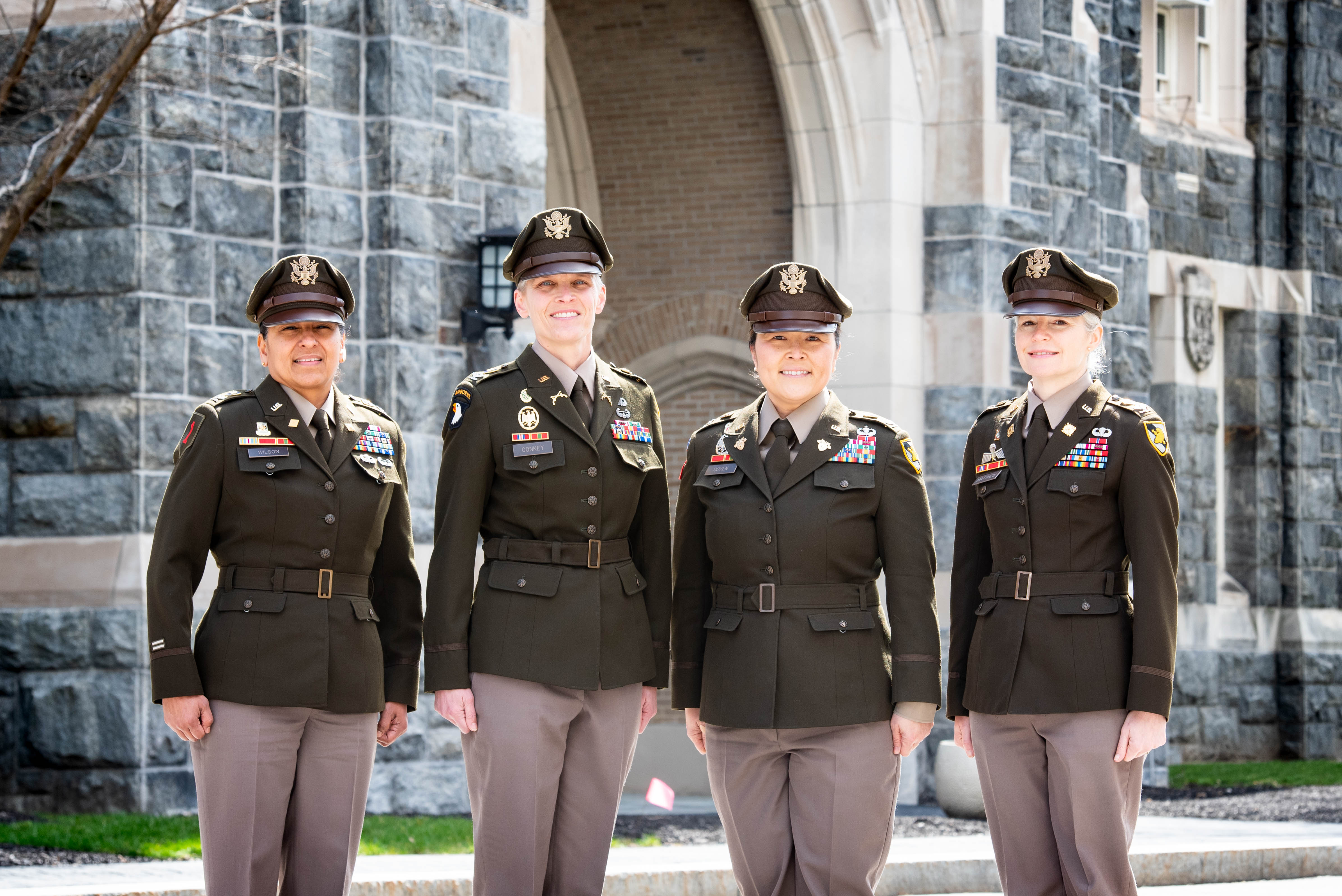 From left to right, Col. Julia Wilson, deputy director of the Department of Physical Education, Col. Kate Conkey, academy professor of The Department of Behavioral Sciences & Leadership, Col. Julia Coxen, academy professor and deputy department head of Systems Engineering, and Col. Katie Matthew, academy professor and program director of the Department of Sociology posing in front of Taylor Hall on March 28 at the U.S. Military Academy. Photo by Elizabeth Woodruff/ USMA PAO.