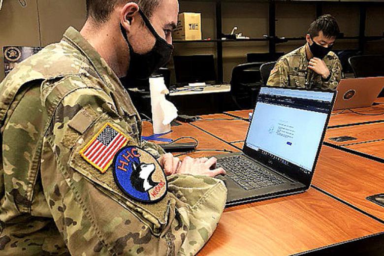 (Left to right) Class of 2021 Cadets Alex Heldstab and Colin Kim from C3T use digital forensics tools to examine artifacts in the mission network. 