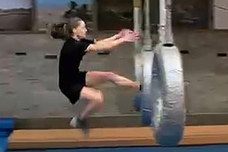 Class of 2022 Cadet Elizabeth Bradley jumps through the hanging tire during the IOCT.                       Video Screenshot