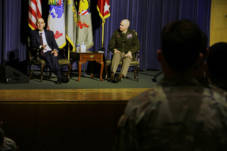 Adam Silver, the commissioner of the National Basketball Association (left), and Maj. Travis Cyphers, the director of the West Point Negotiation Project (right), listen as a cadet inquires about the nuances of negotiation Friday at Robinson Auditorium.   