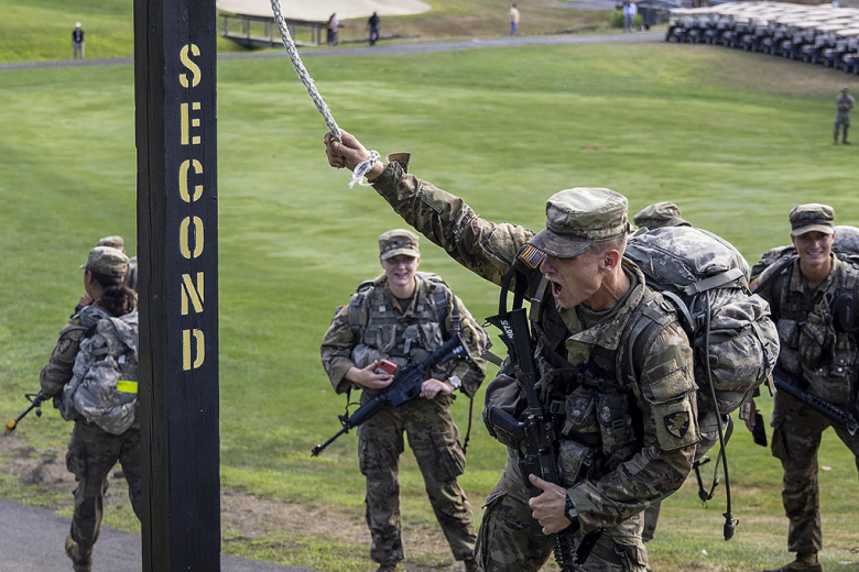 Members of the U.S. Military Academy Class of 2026  ring the bell on the West Point Golf Course during March Back. 