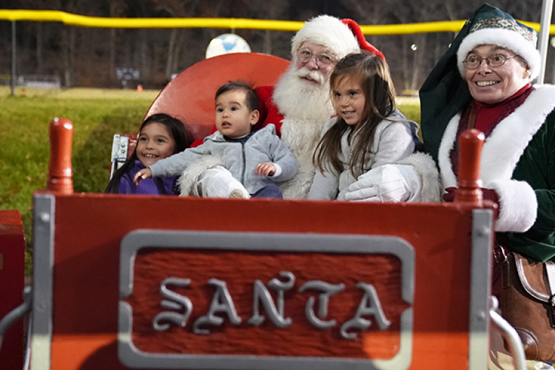 The holiday season went into full throttle as West Point celebrated its annual holiday tree lighting ceremony, hosted by West Point Morale, Welfare and Recreation, Monday at the Exchange. Beyond the lighting of the tree (top), the evening included music from the West Point Cadet Chapel Choir, West Point Band Brass Quintet, the distribution of trees by the Tree for Troops organization and a visit from Santa. (Below) Santa met with the children of the West Point community.  	   