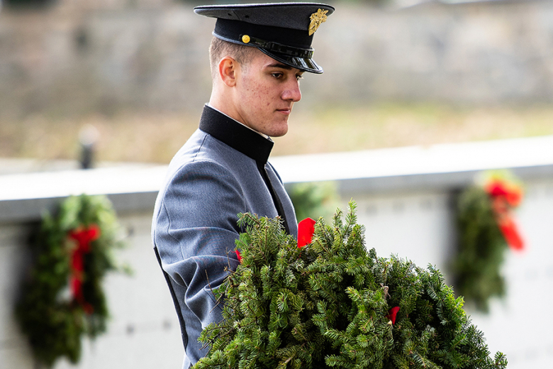 (Above and left) A cadet and veterans from the 101st Airborne Division (Air Assault) help with the placement on wreaths on every grave Saturday at the West Point Cemetery.