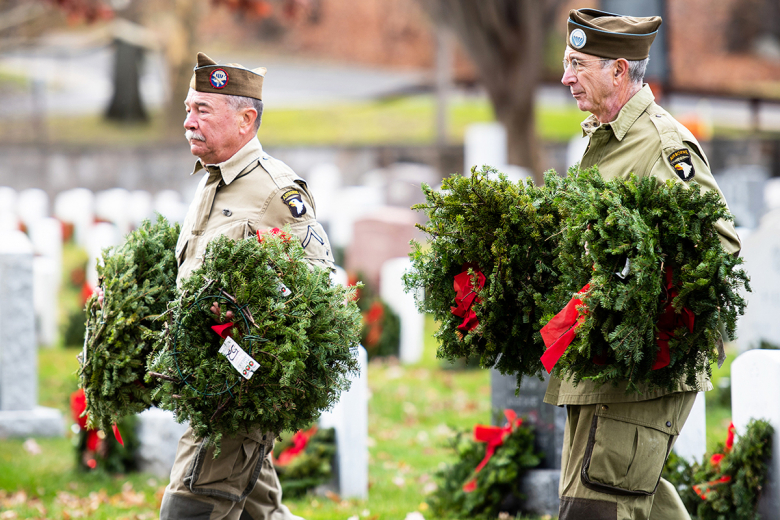 (Above and left) A cadet and veterans from the 101st Airborne Division (Air Assault) help with the placement on wreaths on every grave Saturday at the West Point Cemetery.   (Photo by Jorge Garcia/PV)