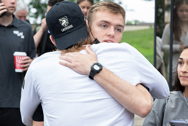 A cadet candidate hugs a family member as he gets ready for his journey on R-Day.   Photo by Michelle Eberhart/USMA PAO