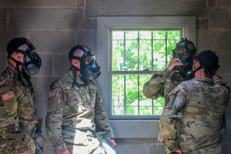 A new cadet from the U.S. Military Academy Class of 2026 gets a lesson in the Chemical, Biological, Radiological and Nuclear (CBRN) gas chamber, also known as “The House of Tears,ˮ July 14 at West Point. The purpose of the gas chamber is to help familiarize cadets with their equipment. (Above) A new cadet checks the functionality of his protective mask before taking it off in the “The House of Tears.ˮ 